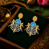 Sterling silver Baroque cherub drop earrings with turquoise medallion and gold shell motif, still life on velvet