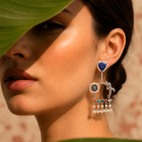 Close-up of a model wearing sterling silver peacock kundan jhumka earrings with lapis lazuli stud
