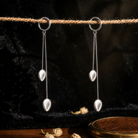 Sterling silver twin chain drop earrings with teardrop beads hanging from a rope